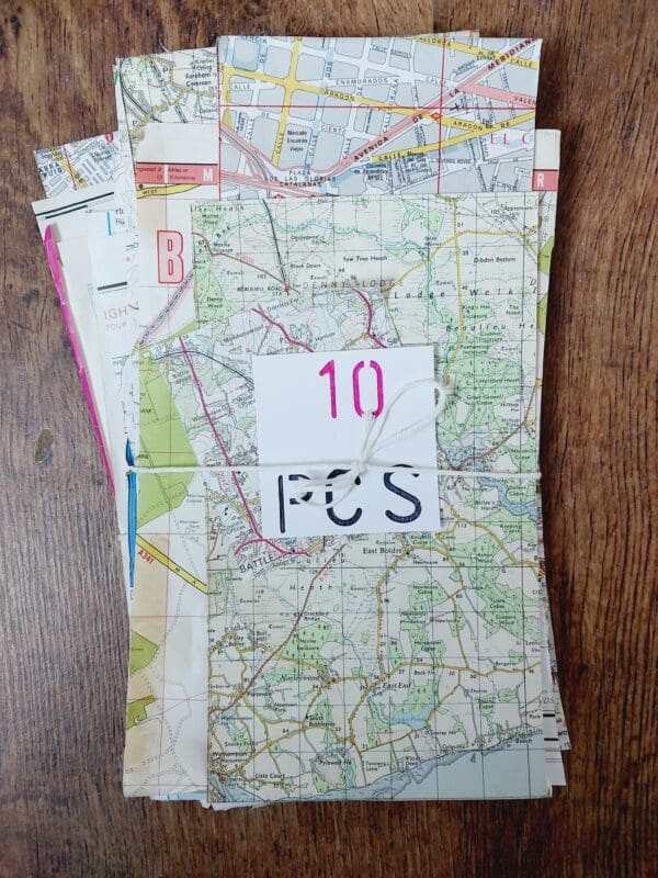 Close-up of small, jagged pieces of maps, showing sections of roads and street names.