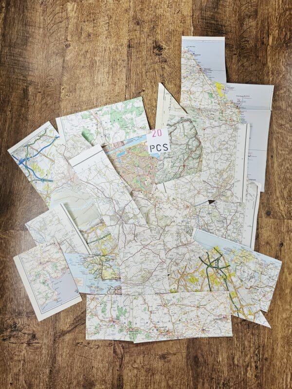 A bundle of pieces of vintage maps with assorted colours and shapes.