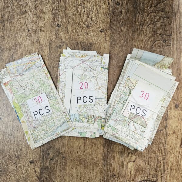 Map paper scraps shown in tied bundles of 10, 20 or 30 pieces put together by Sarah Lou Crafts.