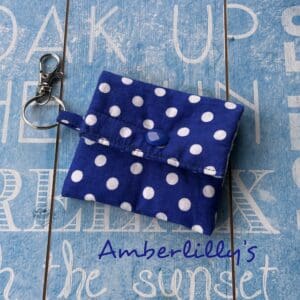 Dark blue and white polka dots fabric keychain ear or hearing aids pouch.