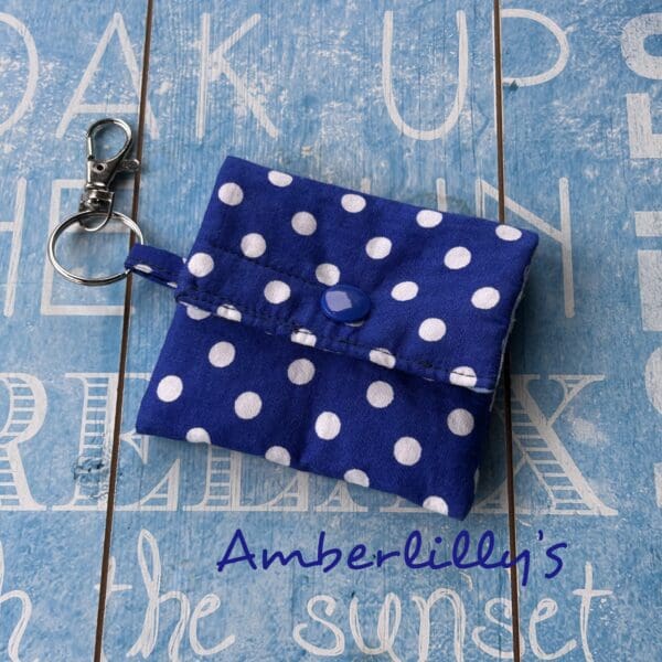 Dark blue and white polka dots fabric keychain ear or hearing aids pouch.