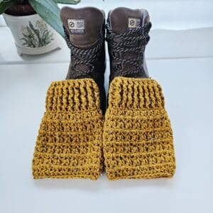 Full view of the crochet boot cuffs laid out together, showing the rich, warm Honeysuckle yellow colour and the consistent stitch work.