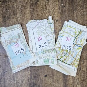 Map paper scraps shown in tied bundles of 10, 20 or 30 pieces put together by Sarah Lou Crafts.