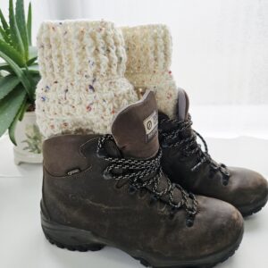 A full-length shot of a pair of black ankle boots with crochet boot cuffs in nougat cream with colourful flecks are visible at the top of the boots.